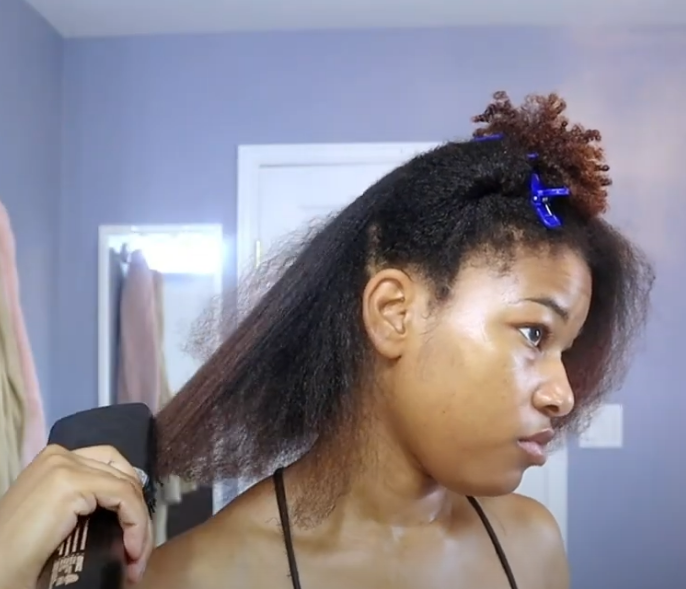 Using a blow dry brush to help stretch natural hair by distributing heat safely